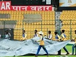 Groundmen cover pitch as it drizzles ahead of the first Test cricket match between India and New Zealand at the M Chinnaswamy Stadium in Bengaluru. Groundmen cover pitch as it drizzles ahead of the first Test cricket match between India and New Zealand at the M Chinnaswamy Stadium in Bengaluru.