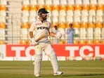 Pakistan's Kamran Ghulam celebrates after reaching his century on his Test debut.