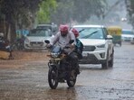 People commute amid rains due to Spawn cyclone in Bengaluru on Tuesday.