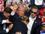 Republican candidate Donald Trump is seen with blood on his face surrounded by Secret Service agents as he is taken off the stage at a campaign event at Butler Farm Show Inc. in Butler, Pennsylvania, July 13, 2024. (Photo by Rebecca DROKE / AFP)