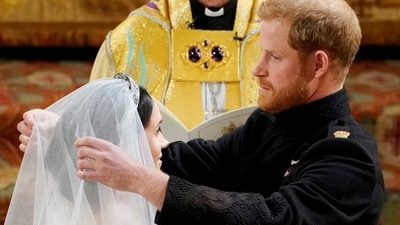 FILE PHOTO: Prince Harry and Meghan Markle in St George's Chapel at Windsor Castle during their wedding service, conducted by the Archbishop of Canterbury Justin Welby in Windsor, Britain, May 19, 2018. Owen Humphreys/Pool via REUTERS/File Photo (via REUTERS)