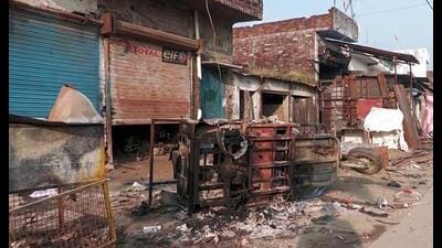 Charred remains are seen outside a shop following the clash between two communities during Durga idol immersion procession, at Mahsi, in Bahraich on Tuesday. (ANI Photo)