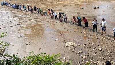 Locals during a drive to rescue fish from the drying Dal Lake in Dharamshala. (File) Locals during a drive to rescue fish from the drying Dal Lake in Dharamshala. (File)