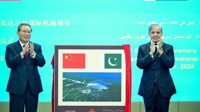 In this handout photograph taken on October 14, 2024, and released by Pakistan's Prime Minister Office, China's Premier Li Qiang (L) and Pakistan's Prime Minister Shehbaz Sharif gesture after unveiling a plaque to mark the completion of New Gwadar International Airport (NGIA) during a ceremony at the Prime Minister House in Islamabad. China's Premier Li Qiang arrived in Pakistan on October 14, on a four-day bilateral visit leading to the Shanghai Cooperation Organisation (SCO) summit, in Islamabad. (AFP)