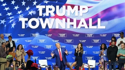 Donald Trump, with moderator and South Dakota Governor Kristi Noem (R), arrives for a town hall at the Greater Philadelphia Expo Center and Fairgrounds in Oaks, Pennsylvania, on October 14, 2024. (Photo by Jim WATSON / AFP) (AFP) Donald Trump, with moderator and South Dakota Governor Kristi Noem (R), arrives for a town hall at the Greater Philadelphia Expo Center and Fairgrounds in Oaks, Pennsylvania, on October 14, 2024. (Photo by Jim WATSON / AFP) (AFP)