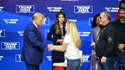 Donald Trump greets the family of US Navy Seal Michael Strange during a town hall, moderated by South Dakota Governor Kristi Noem, at the Greater Philadelphia Expo Center and Fairgrounds in Oaks, Pennsylvania, on October 14, 2024. (AFP) Donald Trump greets the family of US Navy Seal Michael Strange during a town hall, moderated by South Dakota Governor Kristi Noem, at the Greater Philadelphia Expo Center and Fairgrounds in Oaks, Pennsylvania, on October 14, 2024. (AFP)