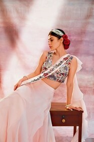Outfit: Nehha Nhata
Jewellery: Crisanto Jewels
Mouni Roy stuns in a sheer pastel saree with delicate ruffles by Nehha Nhata. The saree’s embroidered floral border, which extends to the blouse in vibrant hues of red, blue, and gold, adds a glamorous touch. Her look is completed with a golden headband and minimal jewellery — a bangle, ring, and simple earrings from Crisanto Jewels. Outfit: Nehha Nhata
Jewellery: Crisanto Jewels
Mouni Roy stuns in a sheer pastel saree with delicate ruffles by Nehha Nhata. The saree’s embroidered floral border, which extends to the blouse in vibrant hues of red, blue, and gold, adds a glamorous touch. Her look is completed with a golden headband and minimal jewellery — a bangle, ring, and simple earrings from Crisanto Jewels.