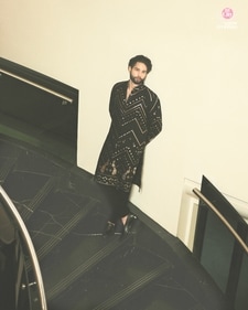 Outfit: Kasbah
Siddhant raises his fashion quotient in this black sherwani with gold embellishments from Kasbah. The sherwani features zigzag design and peacock motifs at the hemline, adding a luxurious touch. He finishes his look with a pair of black churidar-style pants and classic loafers also in black (Sheldon Santos) Outfit: Kasbah
Siddhant raises his fashion quotient in this black sherwani with gold embellishments from Kasbah. The sherwani features zigzag design and peacock motifs at the hemline, adding a luxurious touch. He finishes his look with a pair of black churidar-style pants and classic loafers also in black (Sheldon Santos)