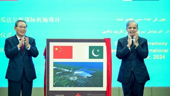 In this handout photograph taken on October 14, 2024, and released by Pakistan's Prime Minister Office, China's Premier Li Qiang (L) and Pakistan's Prime Minister Shehbaz Sharif gesture after unveiling a plaque to mark the completion of New Gwadar International Airport (NGIA) during a ceremony at the Prime Minister House in Islamabad. China's Premier Li Qiang arrived in Pakistan on October 14, on a four-day bilateral visit leading to the Shanghai Cooperation Organisation (SCO) summit, in Islamabad. (AFP)