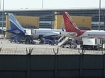 An IndiGo aircraft and an Air India plane on the tarmac at Indira Gandhi International Airport in New Delhi. (Photo for representational purpose only/Bloomberg) An IndiGo aircraft and an Air India plane on the tarmac at Indira Gandhi International Airport in New Delhi. (Photo for representational purpose only/Bloomberg)