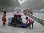 People use a boat on a flooded street to reach safer place during heavy rains in Chennai (AP Photo/Mahesh Kumar A.)