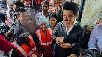 Tamil Nadu Chief Minister MK Stalin sipping tea with sanitation workers after inspecting the unhindered flow of rainwater in the Otteri Canal amid heavy rains, in Chennai on Tuesday. (M.K. Stalin-X)