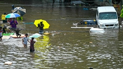 People wade through a flooded street amid heavy rainfall in Chennai on October 15, 2024. (Photo by R.Satish BABU / AFP) (AFP) People wade through a flooded street amid heavy rainfall in Chennai on October 15, 2024. (Photo by R.Satish BABU / AFP) (AFP)