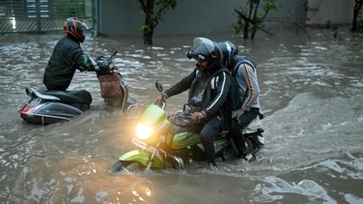 Bengaluru residents commute amid heavy rain. (Representational image) (AFP) Bengaluru residents commute amid heavy rain. (Representational image) (AFP)