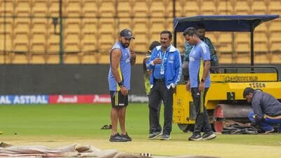 India skipper Rohit Sharma inspects the pitch during a let up in the rain at the M Chinnaswamy Stadium on Wednesday. The first day’s play in the opening Test between India and New Zealand was washed out. (PTI) India skipper Rohit Sharma inspects the pitch during a let up in the rain at the M Chinnaswamy Stadium on Wednesday. The first day’s play in the opening Test between India and New Zealand was washed out. (PTI)