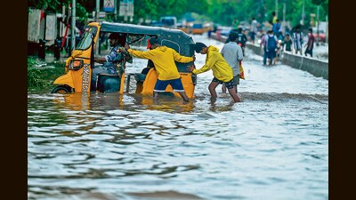 People push an auto-rickshaw stuck on a flooded street amid heavy rainfall in Chennai on Wednesday. (AFP) People push an auto-rickshaw stuck on a flooded street amid heavy rainfall in Chennai on Wednesday. (AFP)
