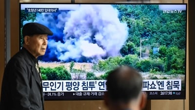 A man walks past a television screen showing a news broadcast with footage of an explosion on a road connecting North and South Korea on October 15, 2024, at a train station in Seoul on October 16, 2024. (AFP) A man walks past a television screen showing a news broadcast with footage of an explosion on a road connecting North and South Korea on October 15, 2024, at a train station in Seoul on October 16, 2024. (AFP)