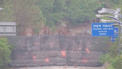 Fire and smoke rises after North Korea blows up sections of inter-Korean roads on its side of the border between the two Koreas, according to South Korea's military, as seen from the South Korean side, October 15, 2024, in this screen grab from a handout video. (Reuters)