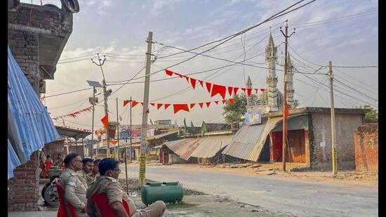 Police personnel keep vigil at a deserted area of Maharajganj after a recent communal violence, in Bahraich district, Wednesday. (PTI Photo)