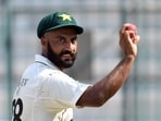Pakistan's Sajid Khan acknowledges the crowd after his seven wicket haul following the end of innings.