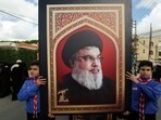 Boys scouts carry a picture of Hezbollah leader Sayyed Hassan Nasrallah during the funeral of  Hezbollah member Ali Mohamed Chalbi after hand-held radios and pagers used by Hezbollah detonated across Lebanon. 
