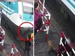 The image captures a phone-using commuter’s close call with an oncoming train. The image captures a phone-using commuter’s close call with an oncoming train.