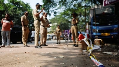Police officers stand at the crime scene next to markings of the gunshots where Nationalist Congress Party (NCP) politician Baba Siddique was shot dead in Mumbai, India, October 13, 2024. (REUTERS)