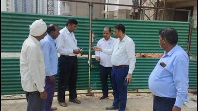 Noida authority officials in the process of sealing one of the four housing project sites on Thursday. (HT Photo) Noida authority officials in the process of sealing one of the four housing project sites on Thursday. (HT Photo)