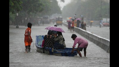 People use a boat on a flooded street to reach a safer place during heavy rains in Chennai on Wednesday. (AP) People use a boat on a flooded street to reach a safer place during heavy rains in Chennai on Wednesday. (AP)