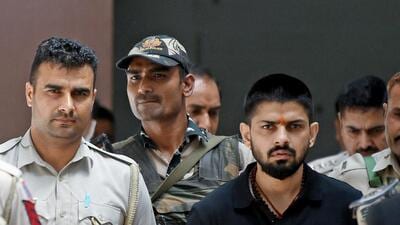 Policemen escort Lawrence Bishnoi in New Delhi in April 2023. (Reuters) Policemen escort Lawrence Bishnoi in New Delhi in April 2023. (Reuters)