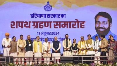 Prime Minister Narendra Modi and Haryana governor Bandaru Dattatreya with newly sworn-in chief minister Nayab Singh Saini and his council of ministers at the Dussehra Ground in Panchkula on Thursday. (PTI Photo) Prime Minister Narendra Modi and Haryana governor Bandaru Dattatreya with newly sworn-in chief minister Nayab Singh Saini and his council of ministers at the Dussehra Ground in Panchkula on Thursday. (PTI Photo)