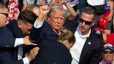 Donald Trump was hit in the ear in an apparent assassination attempt by a gunman at a campaign rally on Saturday, in a chaotic and shocking incident that will fuel fears of instability ahead of the 2024 US presidential election. (Photo by Rebecca DROKE / AFP) Donald Trump was hit in the ear in an apparent assassination attempt by a gunman at a campaign rally on Saturday, in a chaotic and shocking incident that will fuel fears of instability ahead of the 2024 US presidential election. (Photo by Rebecca DROKE / AFP)