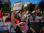 A Pro-Palestinian protester holds a picture of Hamas leader Yahya Sinwar 