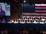 US Vice President Kamala Harris is seen on screen as former US President and Republican presidential candidate Donald Trump with his wife Melania Trump, Archbishop of New York Timothy M. Dolan, Majority Leader of the US Senate Chuck Schumer and many politicians attend the 79th Annual Alfred E. Smith Memorial Foundation Dinner at the Hilton Midtown in New York, October 17, 2024. 