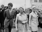 Queen Elizabeth II (centre) with Anne and Charles in 1970 as they passed through the crowds at the Royal Easter Show in Sydney.(PA)