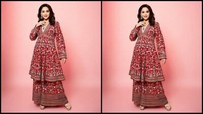 Madhuri Dixit's Anita Dongre kurta set exudes royalty, featuring a deep V-neck and full sleeves adorned with intricate multi-coloured floral embroidery throughout. She paired it with matching wide-flared trousers, creating the perfect festive look. (Instagram/@madhuridixitnene)
