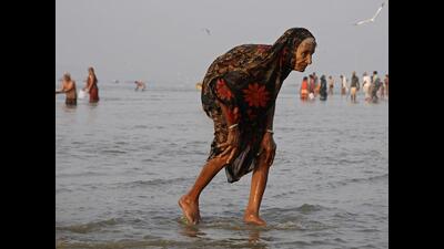 A devotee walks after taking a holy dip in Sangam (File (For Representation)) A devotee walks after taking a holy dip in Sangam (File (For Representation))