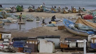 Fishermen children playing in water near the parked boats after heavy rains at Marina beach in Chennai on Oct. 16. (AP) Fishermen children playing in water near the parked boats after heavy rains at Marina beach in Chennai on Oct. 16. (AP)