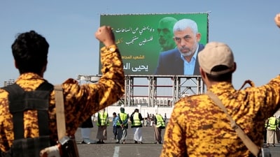 Yemeni soldiers shout slogans in front of a billboard showing Hamas leader Yahya Sinwar during an anti-Israel rally in Sanaa, Yemen, Friday, Oct. 18, 2024. Arabic reads, "martyr Yahya Sinwar". (AP) Yemeni soldiers shout slogans in front of a billboard showing Hamas leader Yahya Sinwar during an anti-Israel rally in Sanaa, Yemen, Friday, Oct. 18, 2024. Arabic reads, "martyr Yahya Sinwar". (AP)