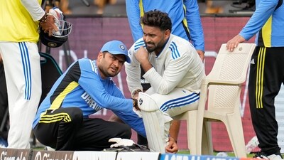India's Rishabh Pant reacts in pain as he is attended by a member of support staff after getting hurt during the day two of the first cricket test match between India and New Zealand at the M.Chinnaswamy Stadium, in Bengaluru, India (AP)