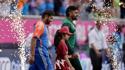 Pakistan's Babar Azam, right, and India's captain Rohit Sharma walk into the field before the start of the ICC Men's T20 World Cup (PTI) Pakistan's Babar Azam, right, and India's captain Rohit Sharma walk into the field before the start of the ICC Men's T20 World Cup (PTI)