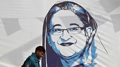 A policeman walks past a portrait of former Bangladesh's prime minister Sheikh Hasina in Dhaka on January 8, 2024. (AFP) A policeman walks past a portrait of former Bangladesh's prime minister Sheikh Hasina in Dhaka on January 8, 2024. (AFP)
