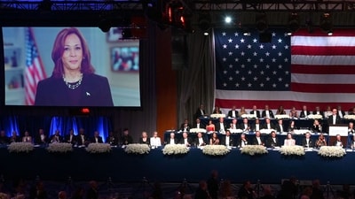 US Vice President Kamala Harris is seen on screen as former US President and Republican presidential candidate Donald Trump with his wife Melania Trump, Archbishop of New York Timothy M. Dolan, Majority Leader of the US Senate Chuck Schumer and many politicians attend the 79th Annual Alfred E. Smith Memorial Foundation Dinner at the Hilton Midtown in New York, October 17, 2024. (AFP)