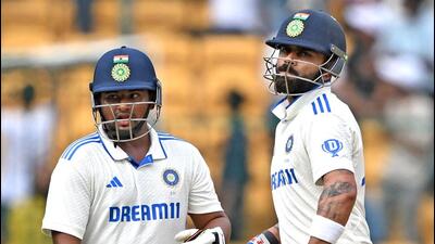 Virat Kohli and Sarfaraz Khan during the third day’s play of the first Test at the M. Chinnaswamy Stadium in Bengaluru. (AFP)