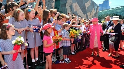 Queen Elizabeth II smiles as she is given flowers by two young girls in Federation Square, Melbourne, during a walkabout in the south Australian city in 2011 (John Stillwell/PA) Queen Elizabeth II smiles as she is given flowers by two young girls in Federation Square, Melbourne, during a walkabout in the south Australian city in 2011 (John Stillwell/PA)