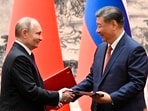 Chinese President Xi Jinping, right, and Russian President Vladimir Putin exchange documents after a signing ceremony during their meeting in Beijing, China. (AP)