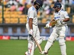 India's Sarfaraz Khan (R) arrives to bat as captain Rohit Sharma (L) walks back to the pavilion after his dismissal during the third day of the first Test cricket match between India and New Zealand at the M. Chinnaswamy Stadium in Bengaluru on October 18, 2024. (Photo by IDREES MOHAMMED / AFP) / -- IMAGE RESTRICTED TO EDITORIAL USE - STRICTLY NO COMMERCIAL USE -- India's Sarfaraz Khan (R) arrives to bat as captain Rohit Sharma (L) walks back to the pavilion after his dismissal during the third day of the first Test cricket match between India and New Zealand at the M. Chinnaswamy Stadium in Bengaluru on October 18, 2024. (Photo by IDREES MOHAMMED / AFP) / -- IMAGE RESTRICTED TO EDITORIAL USE - STRICTLY NO COMMERCIAL USE --