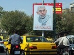 People drive past a banner bearing a portrait of Hamas' slain leader Yahya Sinwar at at a street in Tehran, on October 19, 2024. Iran's supreme leader Ayatollah Ali Khamenei said on October 19 that Hamas was alive and will survive despite the death of its leader Yahya Sinwar in an Israeli military operation in Gaza. (Photo by AFP)