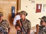 Security personnel stand guard during a raid by the Enforcement Directorate on the Mysuru Urban Development Authority (MUDA) office.