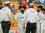 Indian captain Rohit Sharma and other players interact with umpires after bad light stopped play on the fourth day of the first test cricket match between India and New Zealand Indian captain Rohit Sharma and other players interact with umpires after bad light stopped play on the fourth day of the first test cricket match between India and New Zealand